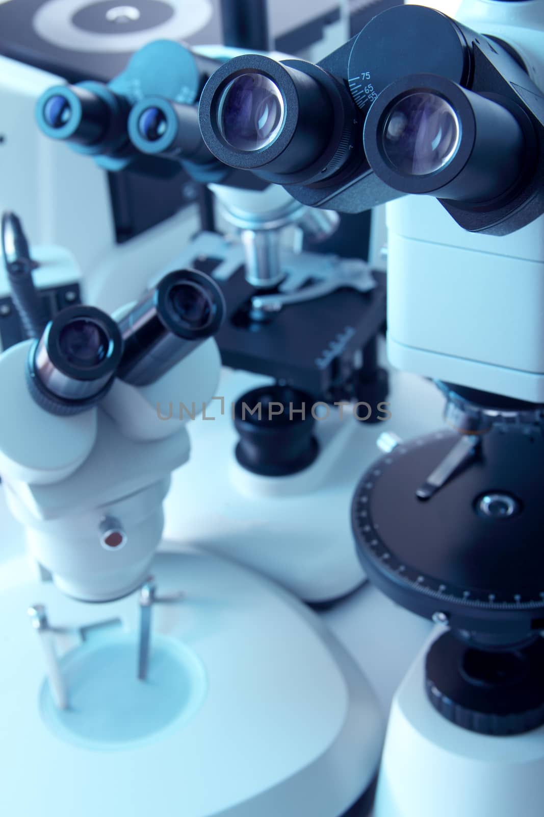 Group of various Microscopes in blue medicine light