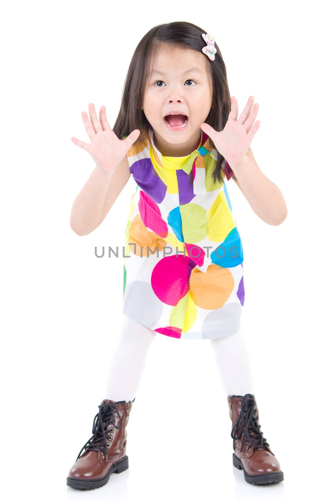 Excited asian little child open her mouth and raising her hand 