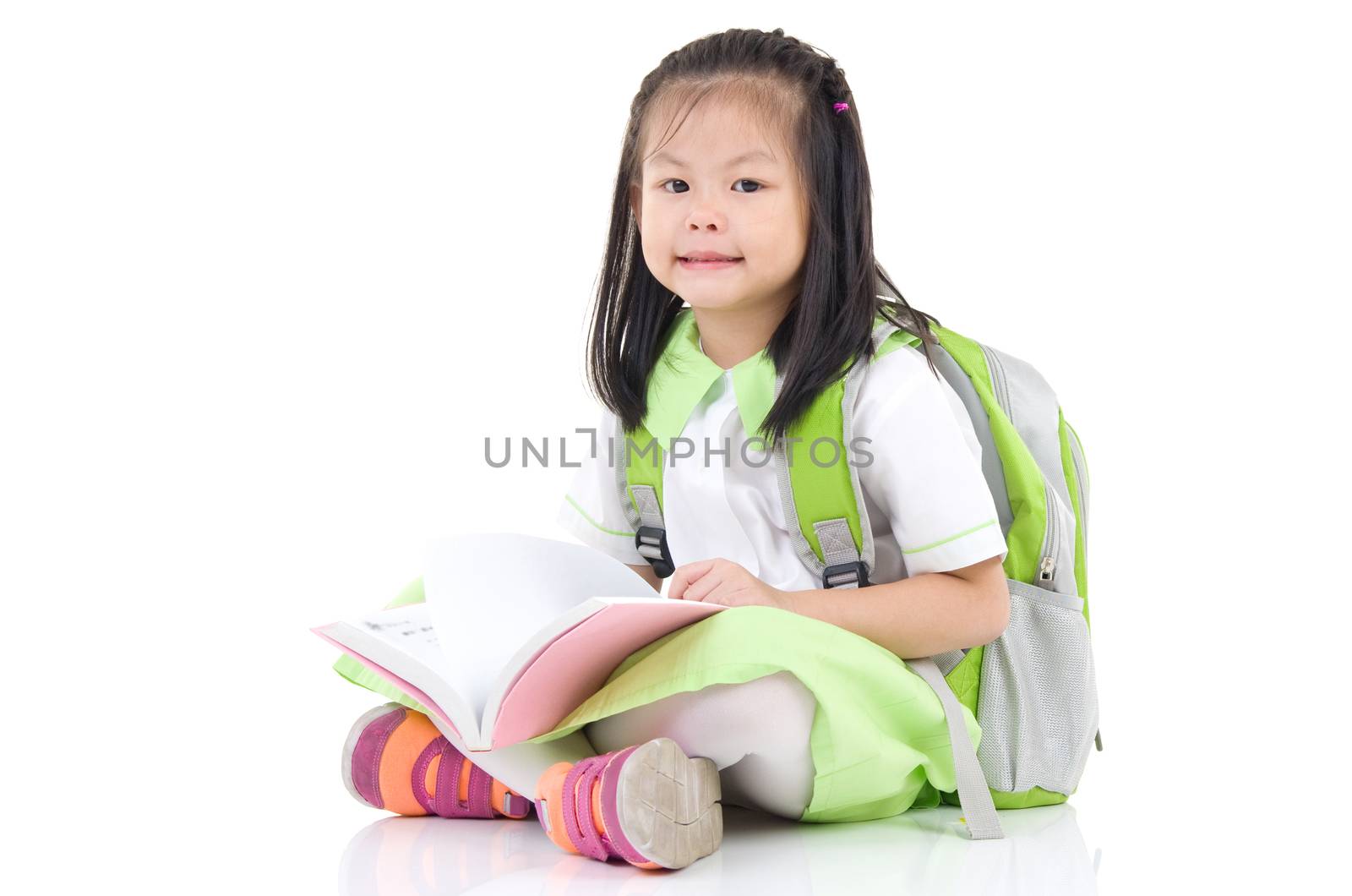 Happy little schoolgirl with books isolated on white background