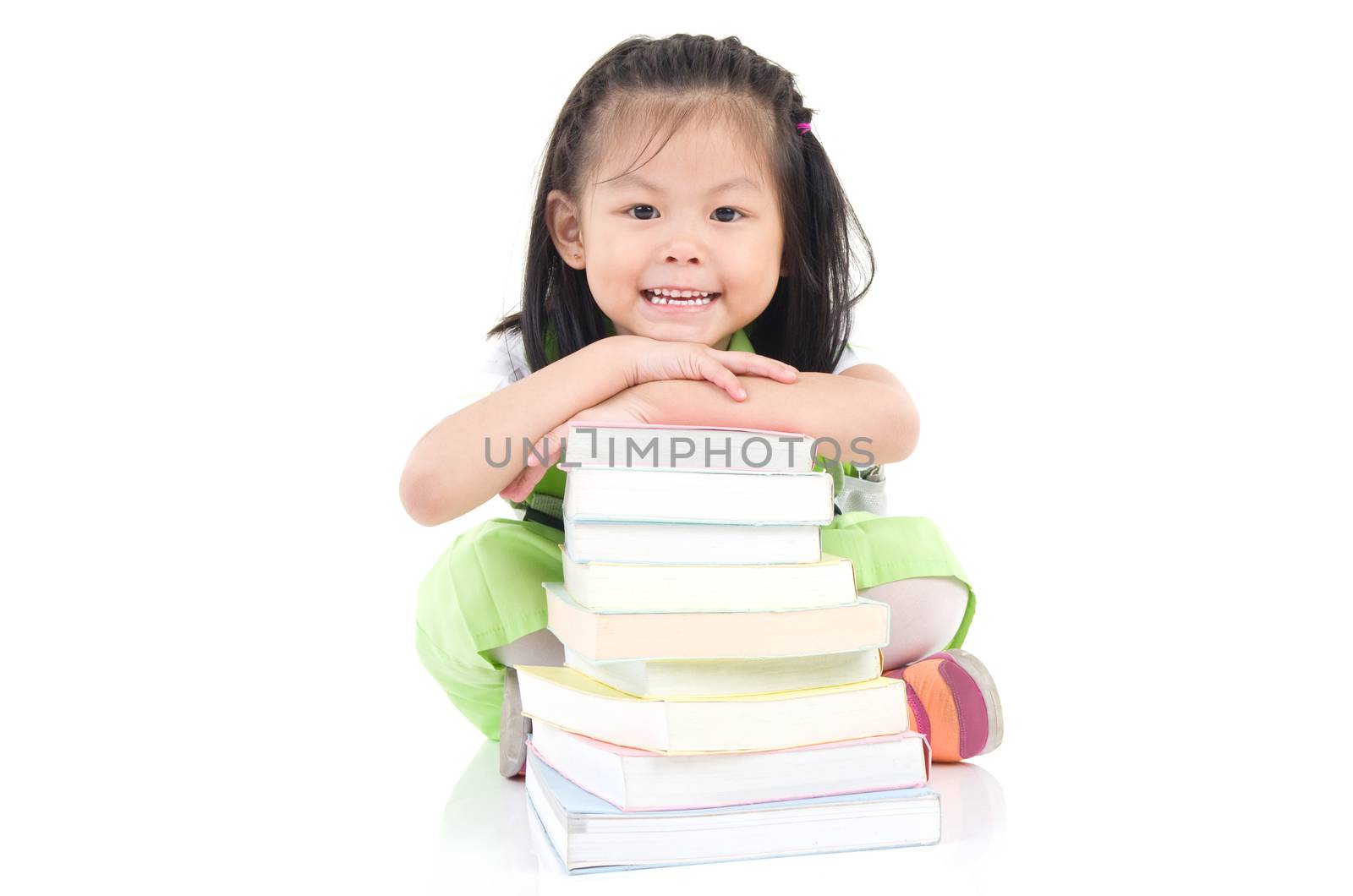 Happy little schoolgirl with books isolated on white background