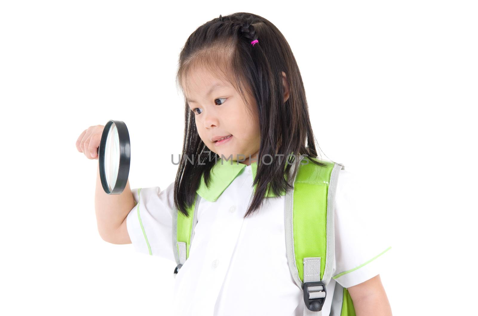 little asian girl looking through magnifying glass , isolated on white background. School, education concept.