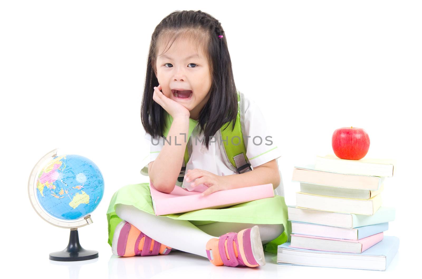 Happy little schoolgirl with books and globe, isolated on white background