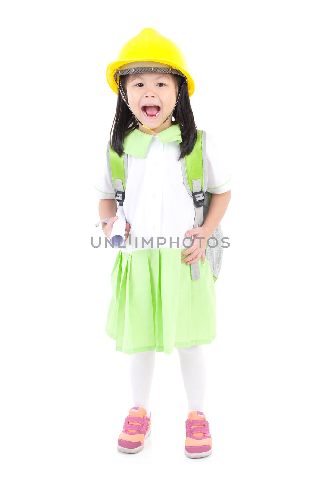 Asian primary student carried school bag, wearing the construction helmet and holding a construction drawing, isolated over white background.