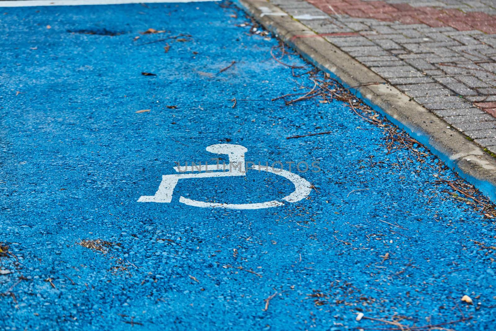 disabled sign painted on asphalt by rasika108