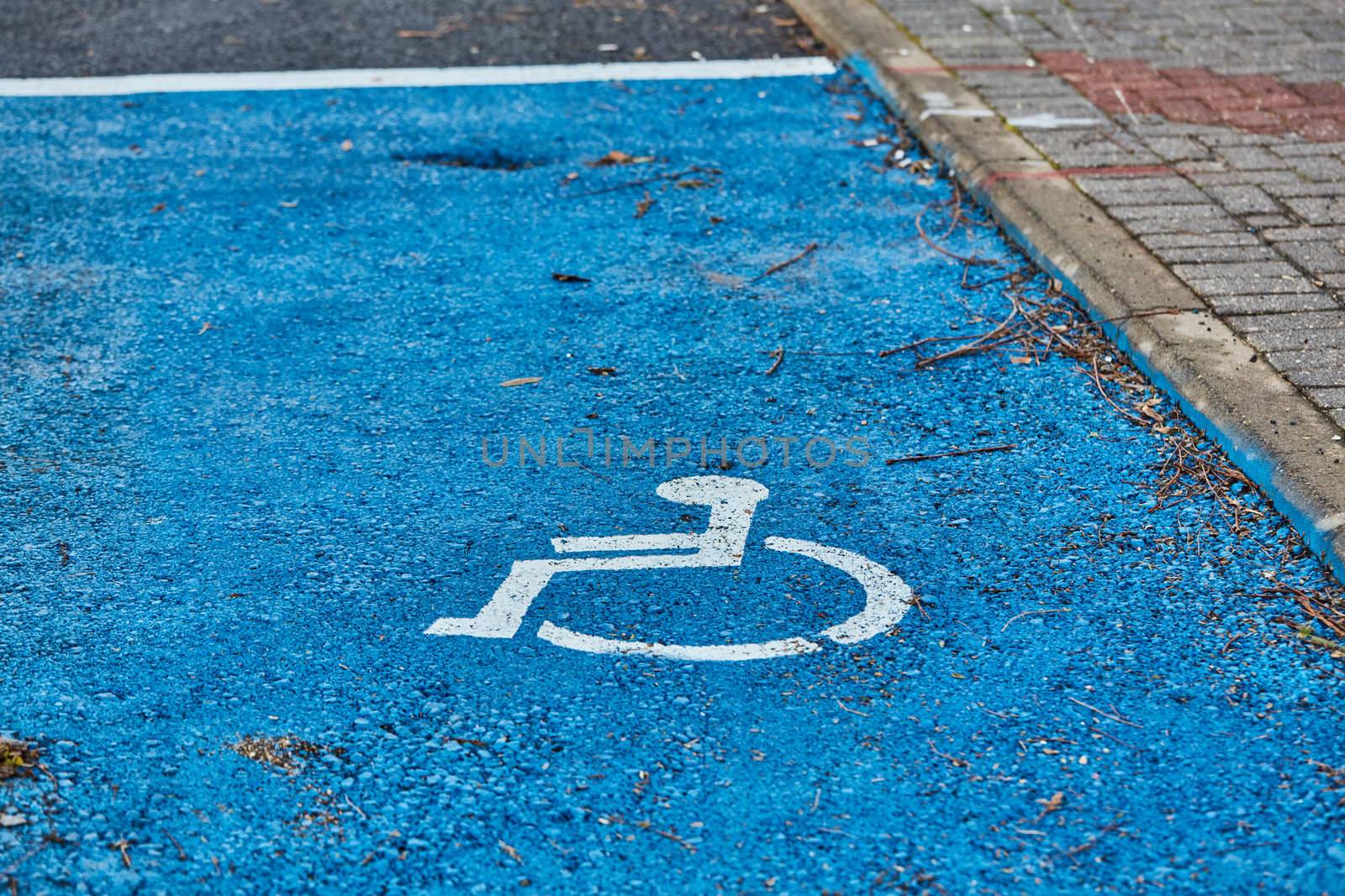 disabled sign painted on asphalt