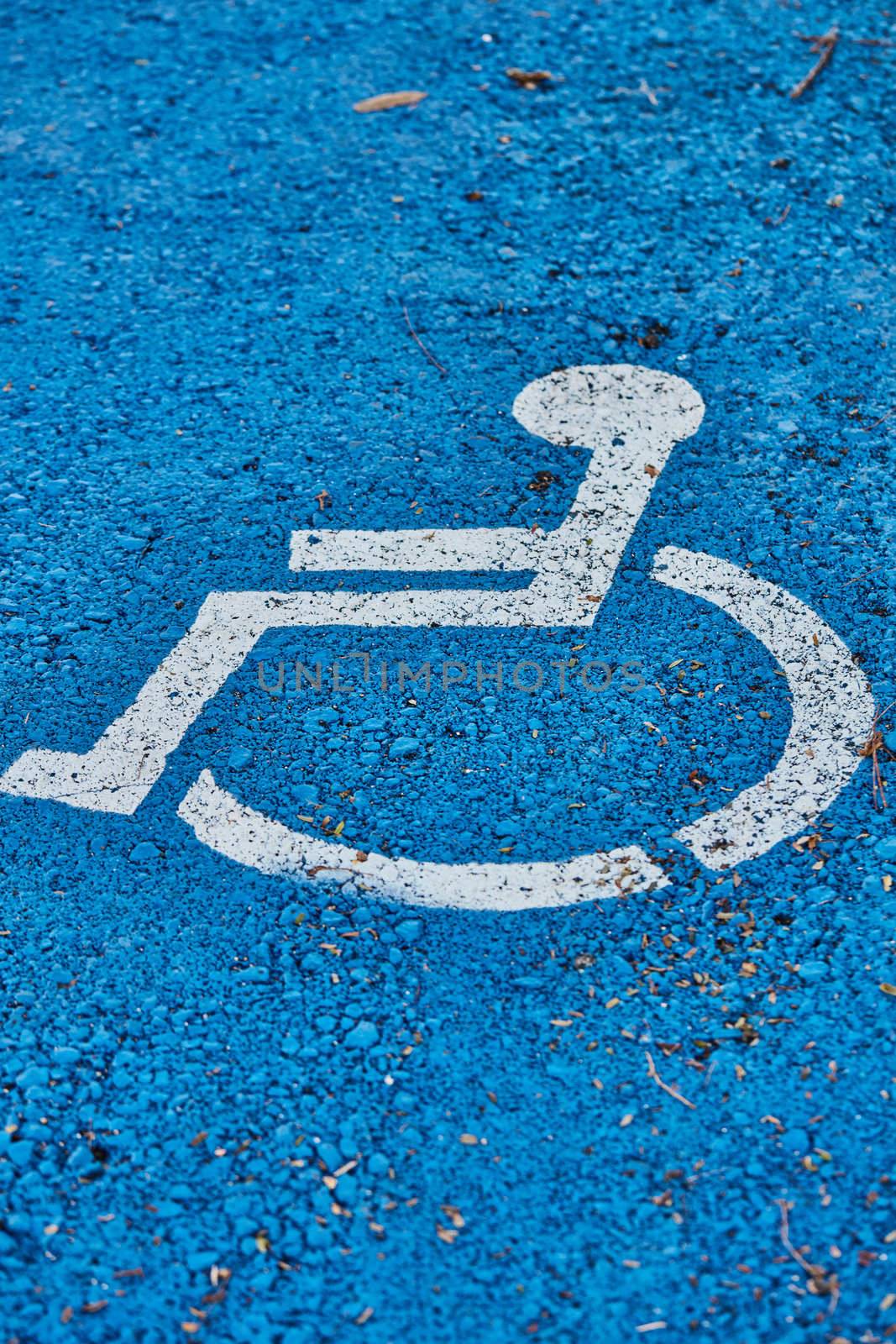 disabled sign painted on asphalt