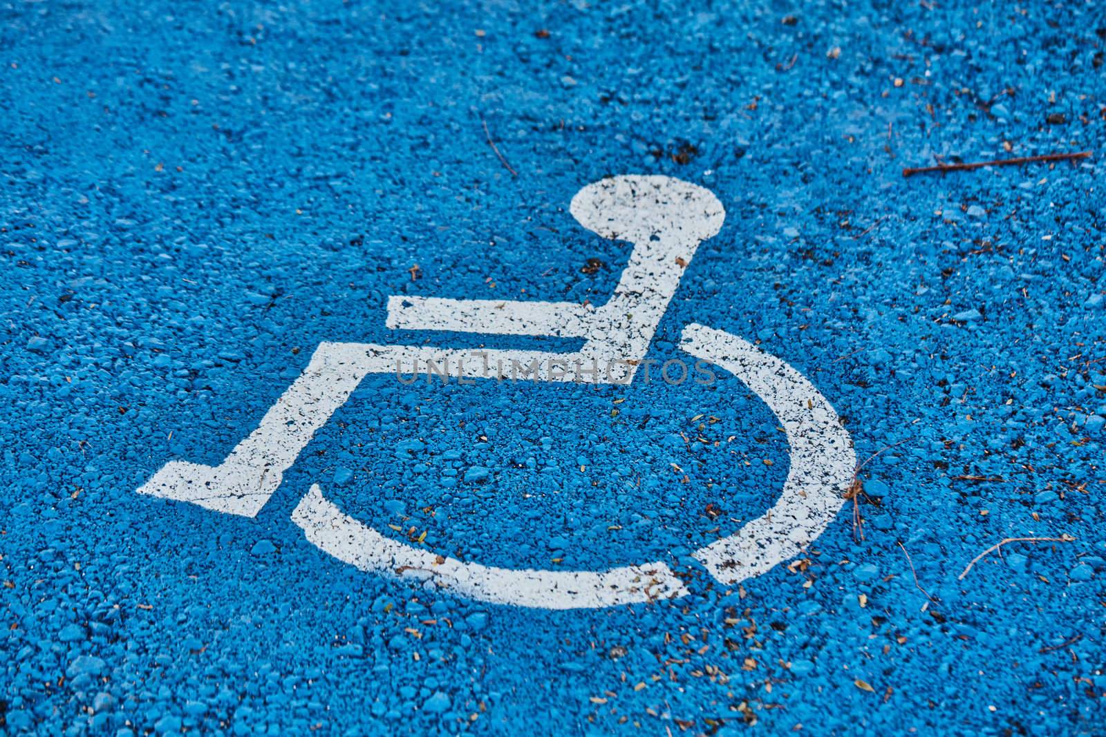 disabled sign painted on asphalt
