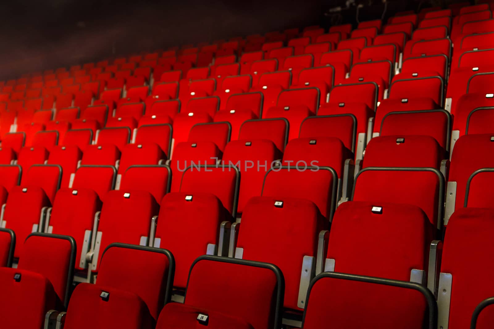 many rows of red theater seats indoors