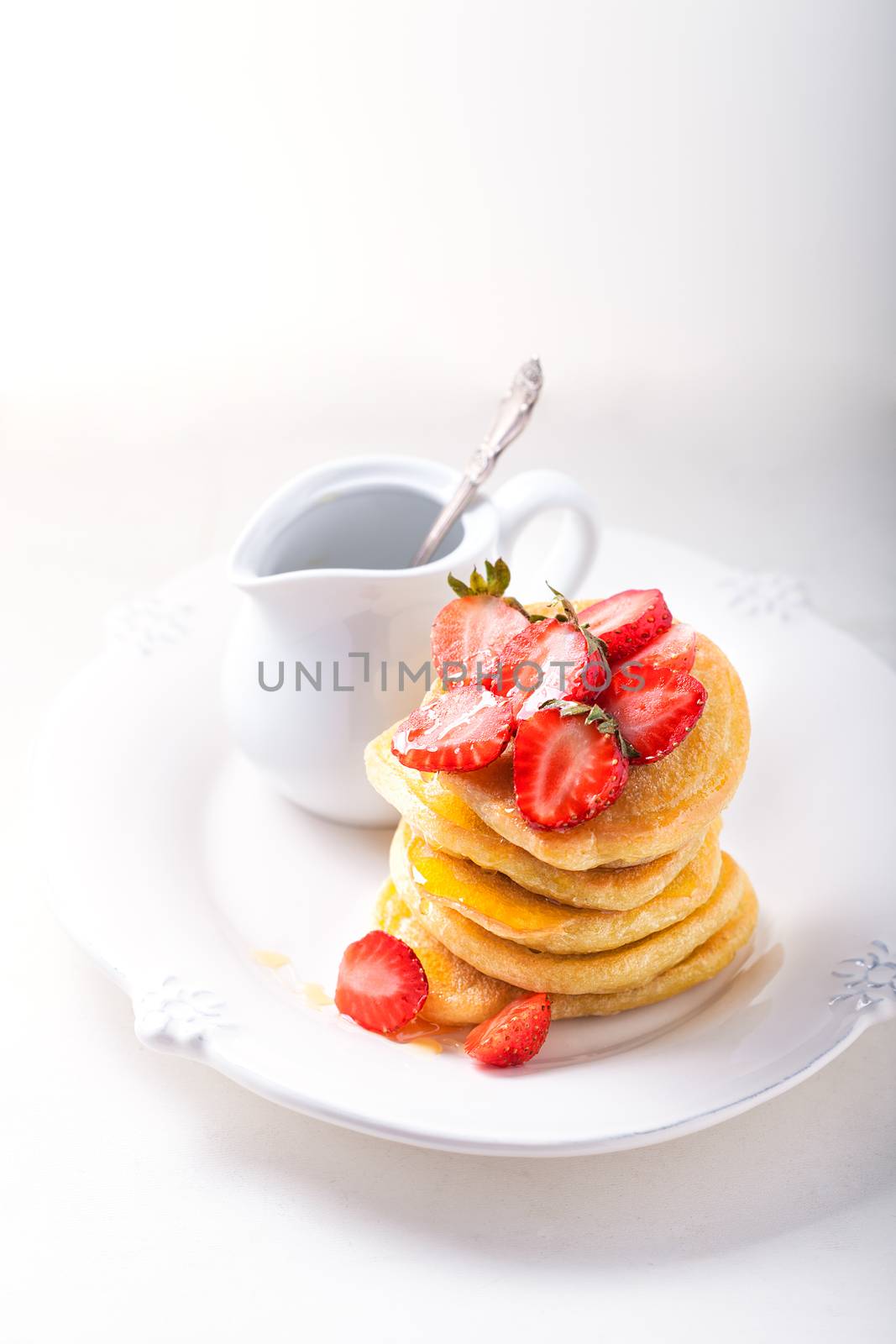 Stack of sweet pancakes with strawberry and honey. Gluten free flour.
