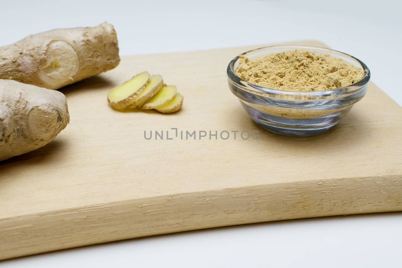 Ginger root, slices and powder on a white background