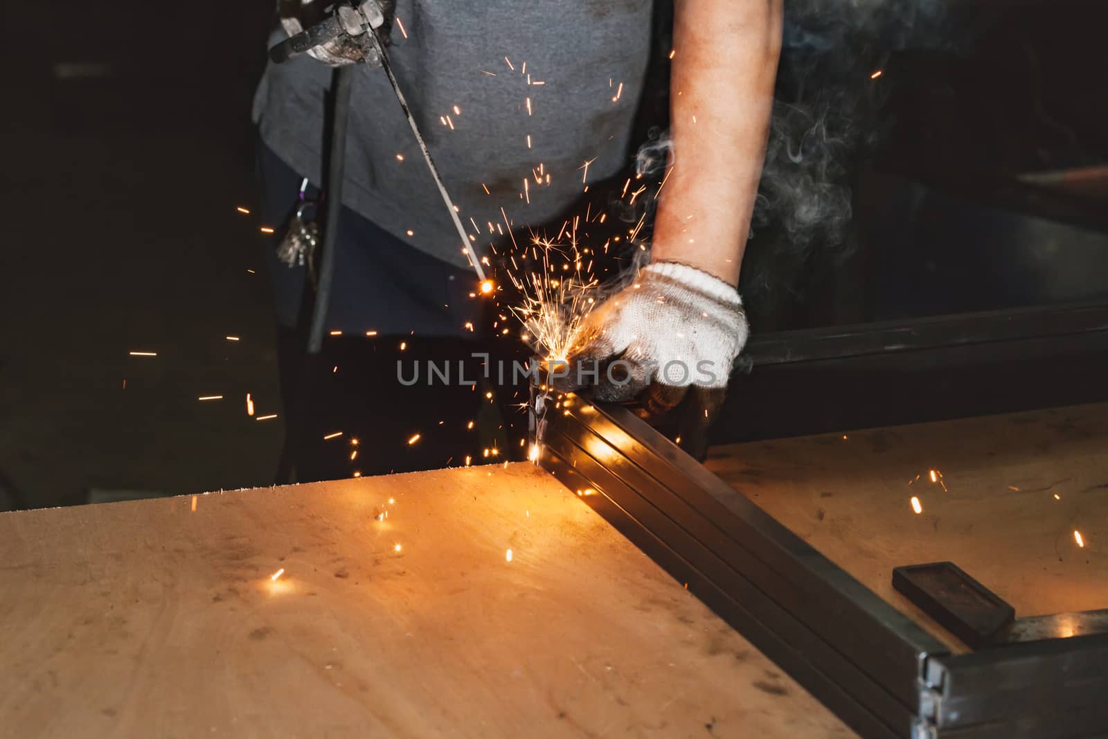 Men welder on a workshop .