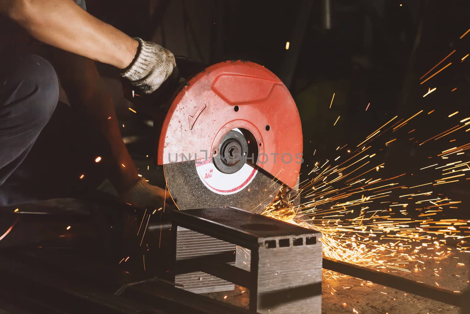 Men use Electric grinder on a workshop.