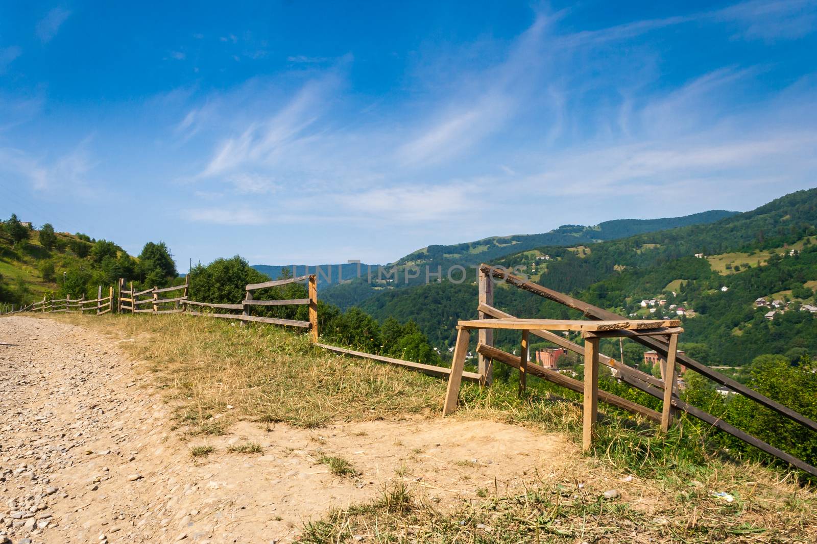 wooden stck fence in mountains with blue sky