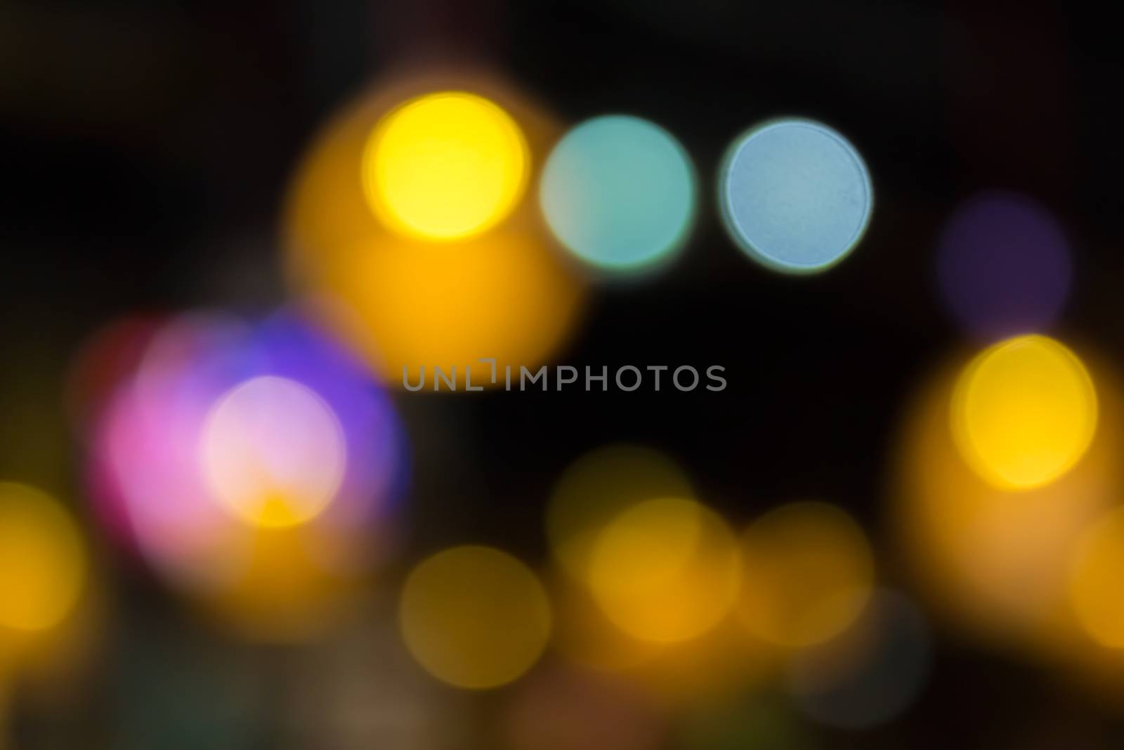 abstract background of blurred warm 
lights with cool blue and purple spots with bokeh effect