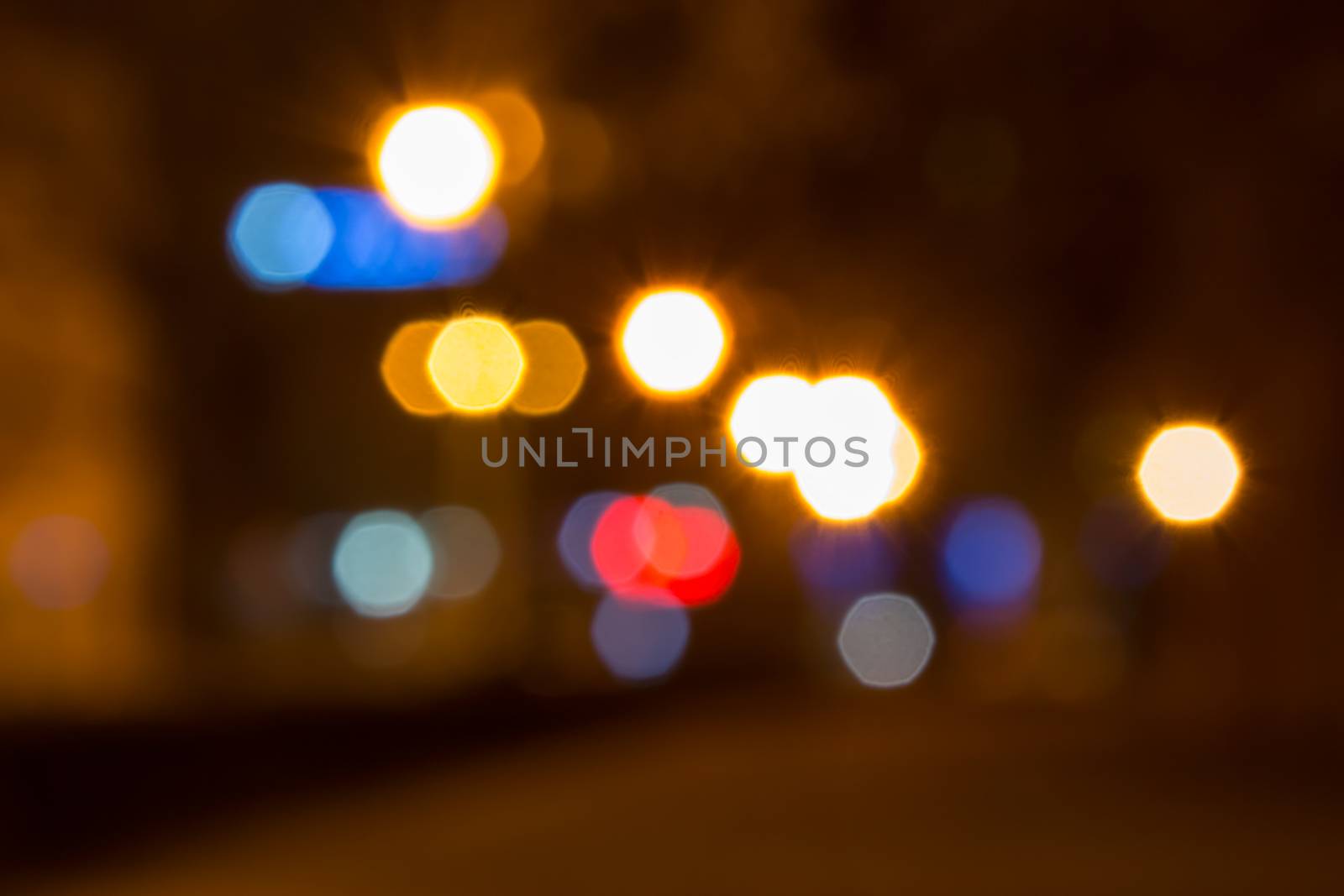abstract background of blurred warm 
and cool lights with warm background with red spots with bokeh effect