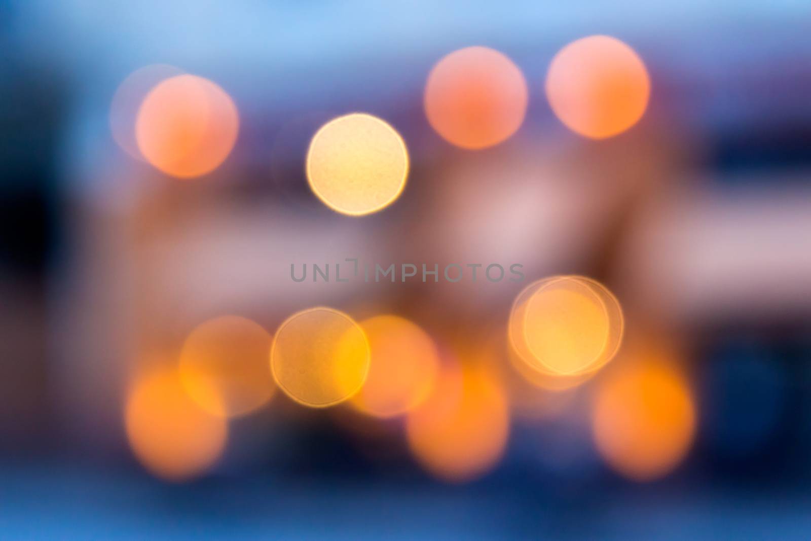 abstract background of blurred warm 
lights with cool blue and purple background with bokeh effect