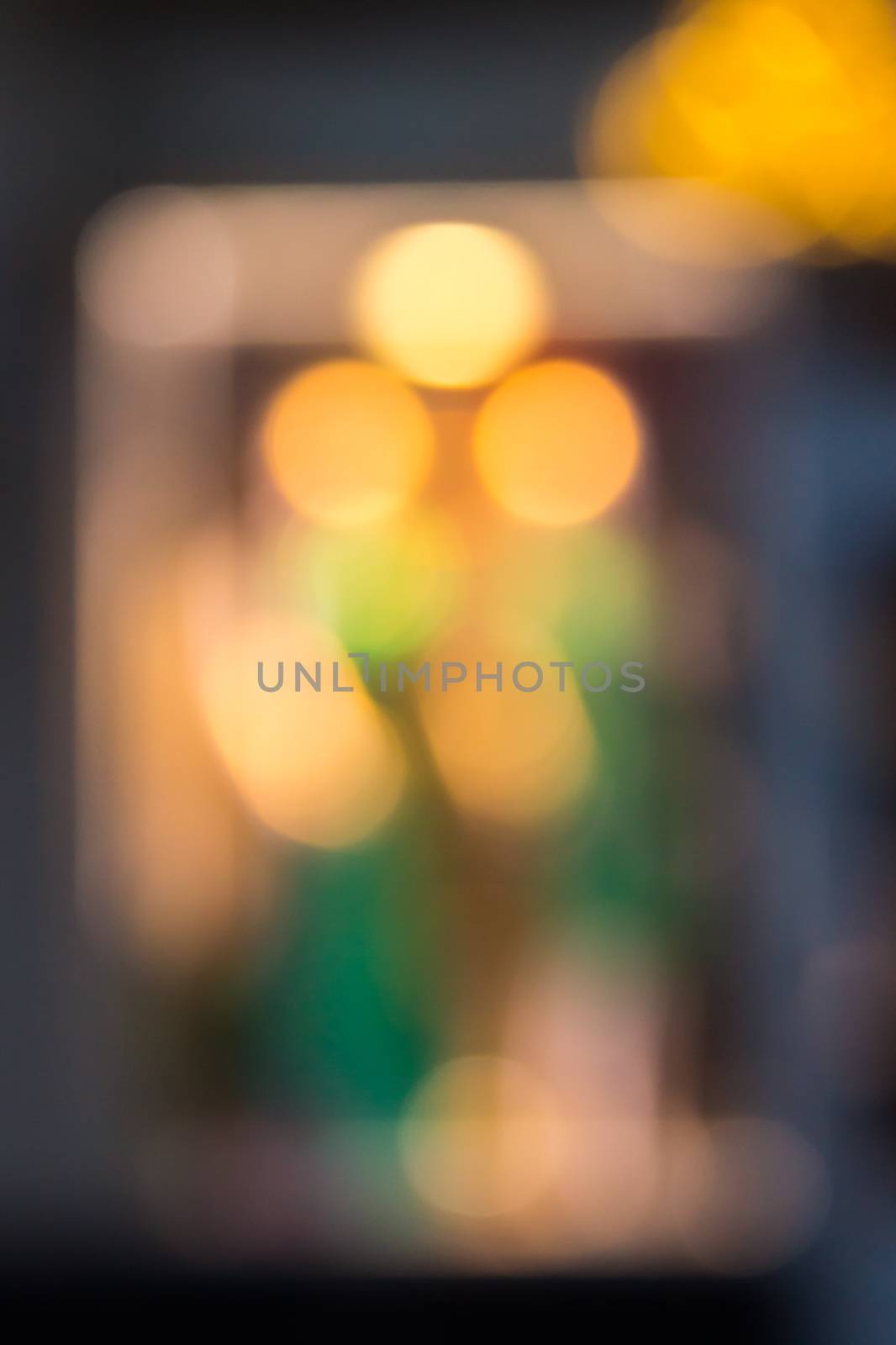 abstract flower background of blurred warm lights with green spots with bokeh effect