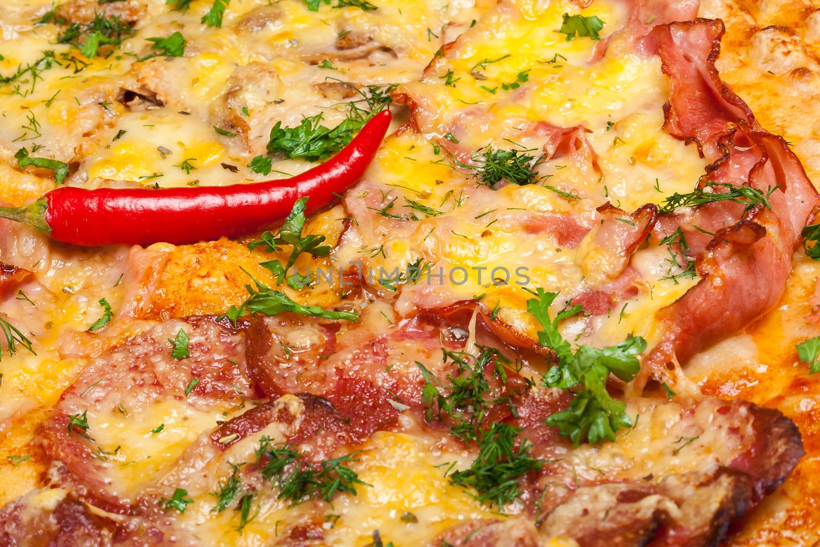 pizza with chili peppers, bacon; salami and cheese, close-up