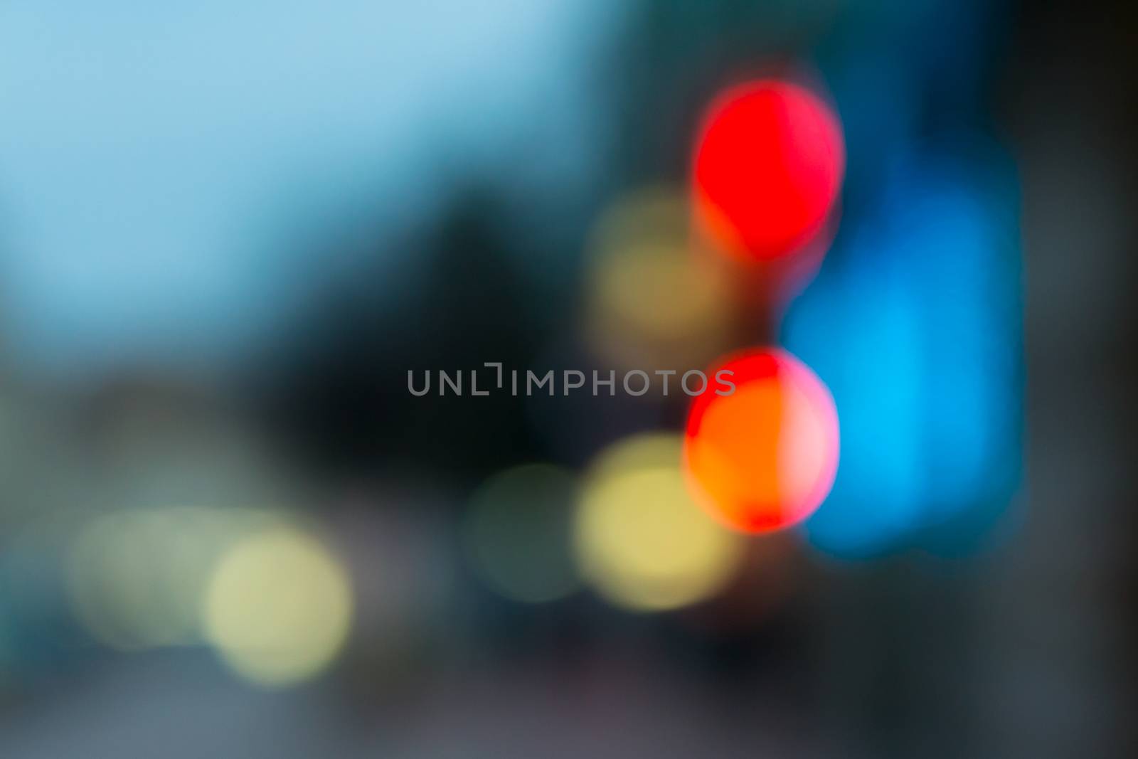 abstract cityscape background of blurred warm 
lights with hot red spot with bokeh effect