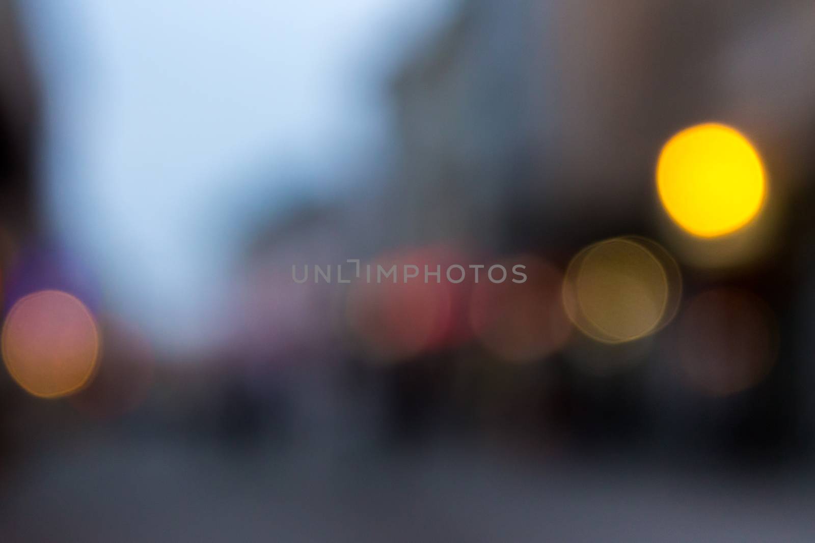 abstract cityscape background of blurred warm 
lights with cool violet spot with bokeh effect