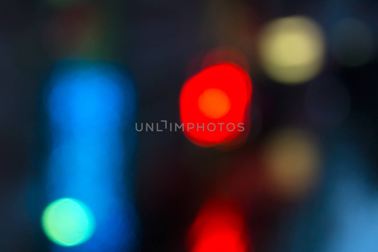 abstract evning blue background of blurred cool lights with red hot spot with bokeh effect