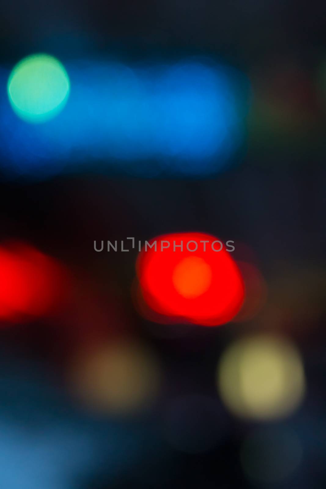 abstract evning blue background of blurred cool lights with red hot spot with bokeh effect