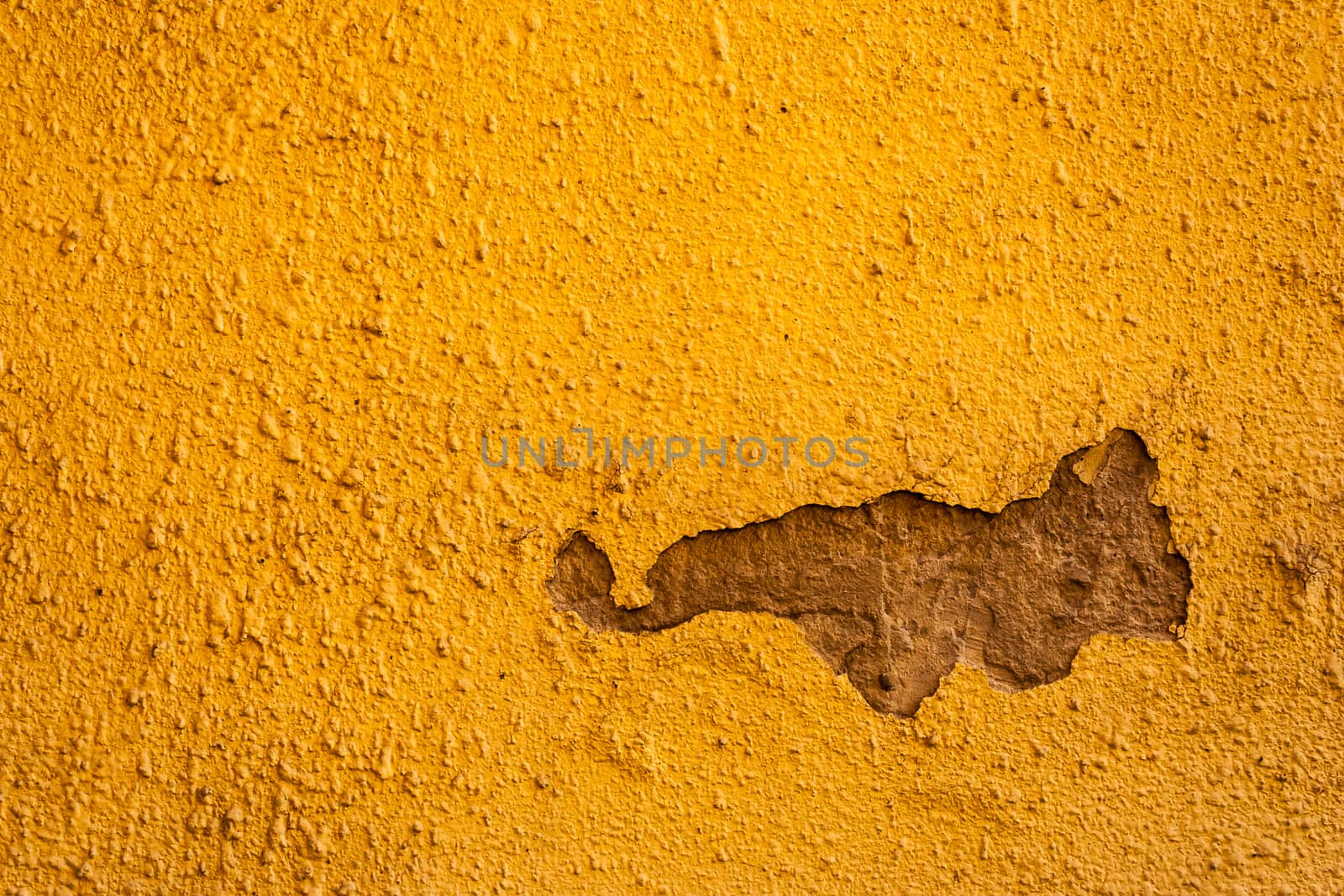 Old yellow with artistic cracked wall with a bummer