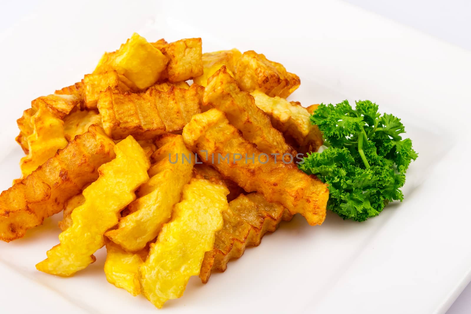 fried sliced ​​curly sticks potatoes chips with parsley