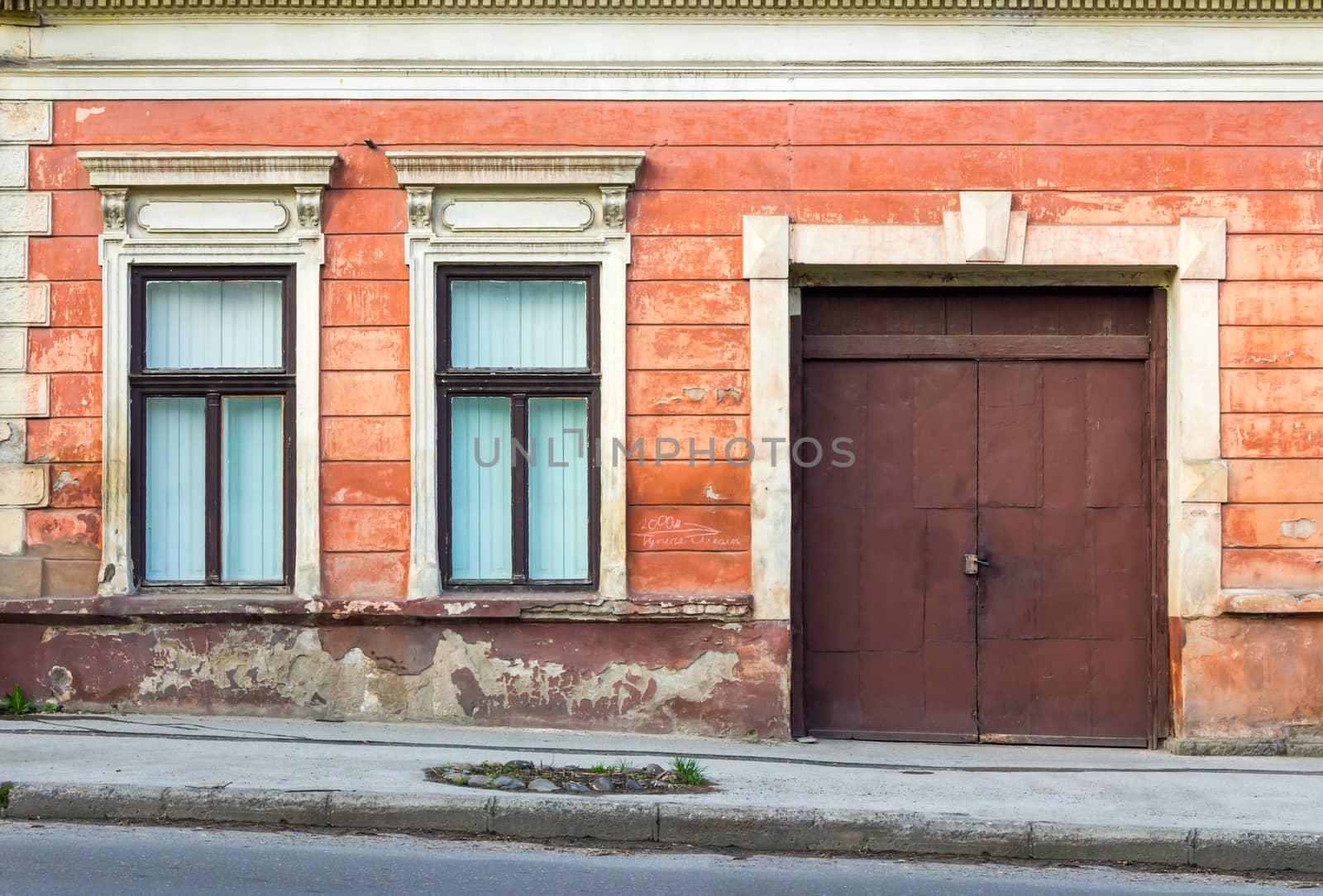 facade of an old building with two windows and  door by Pellinni