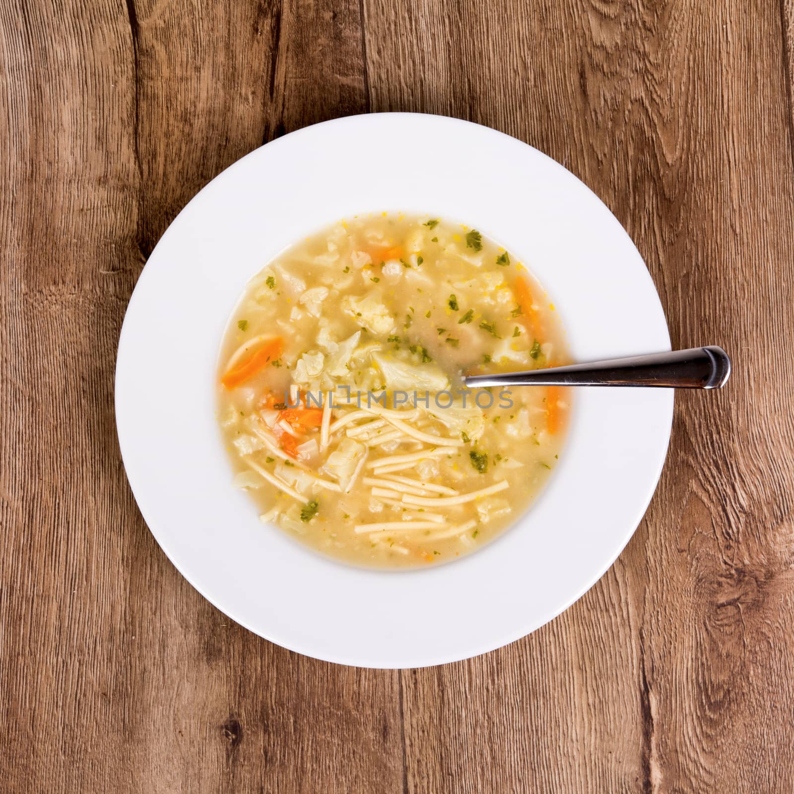 Vegetarian vegetable soup on a wooden table