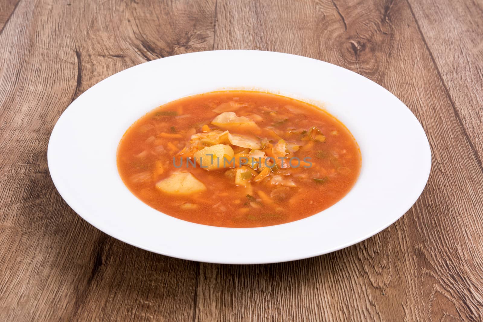 Vegetarian vegetable soup on a wooden table