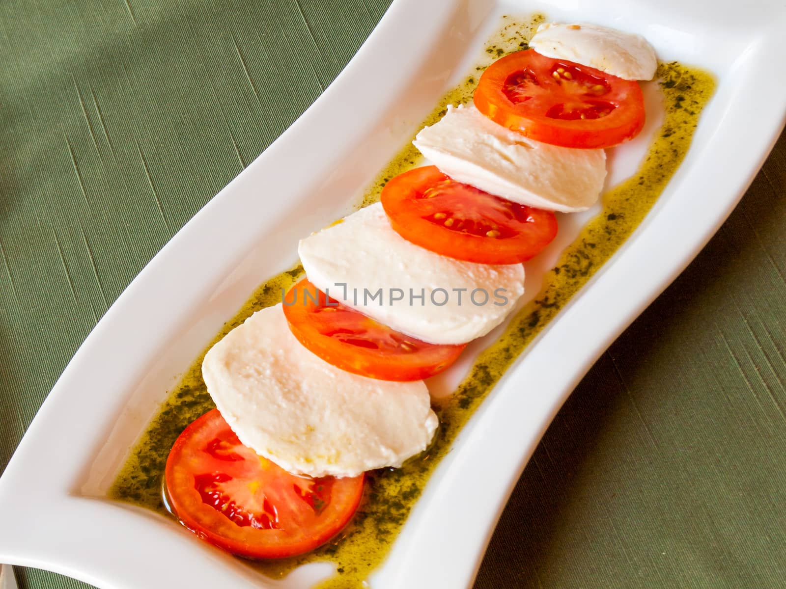 Summer Classic Italian salad. Salad of red juicy tomatoes, fresh and soft mozzarella cheese and sauce