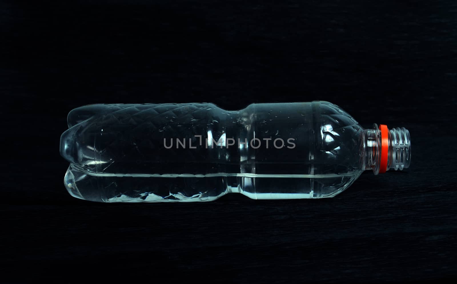 plastic bottle with water on a black background by nehru