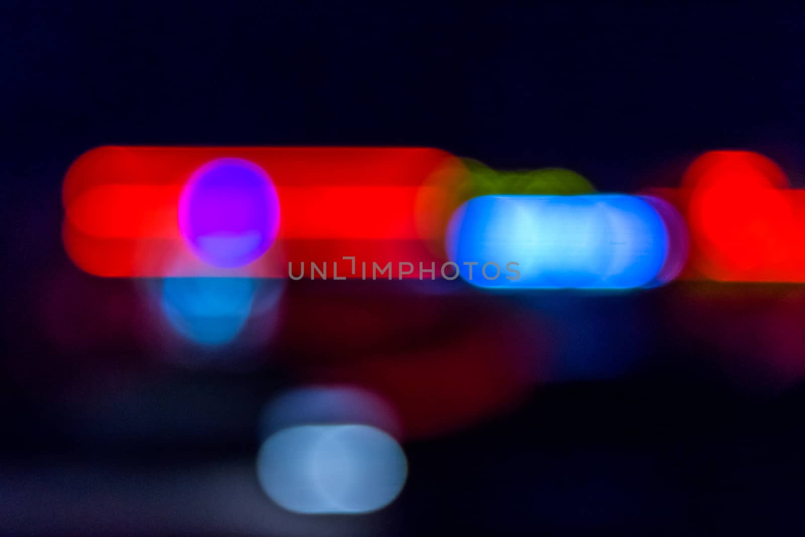 abstract blur of red blue police car sirens at night