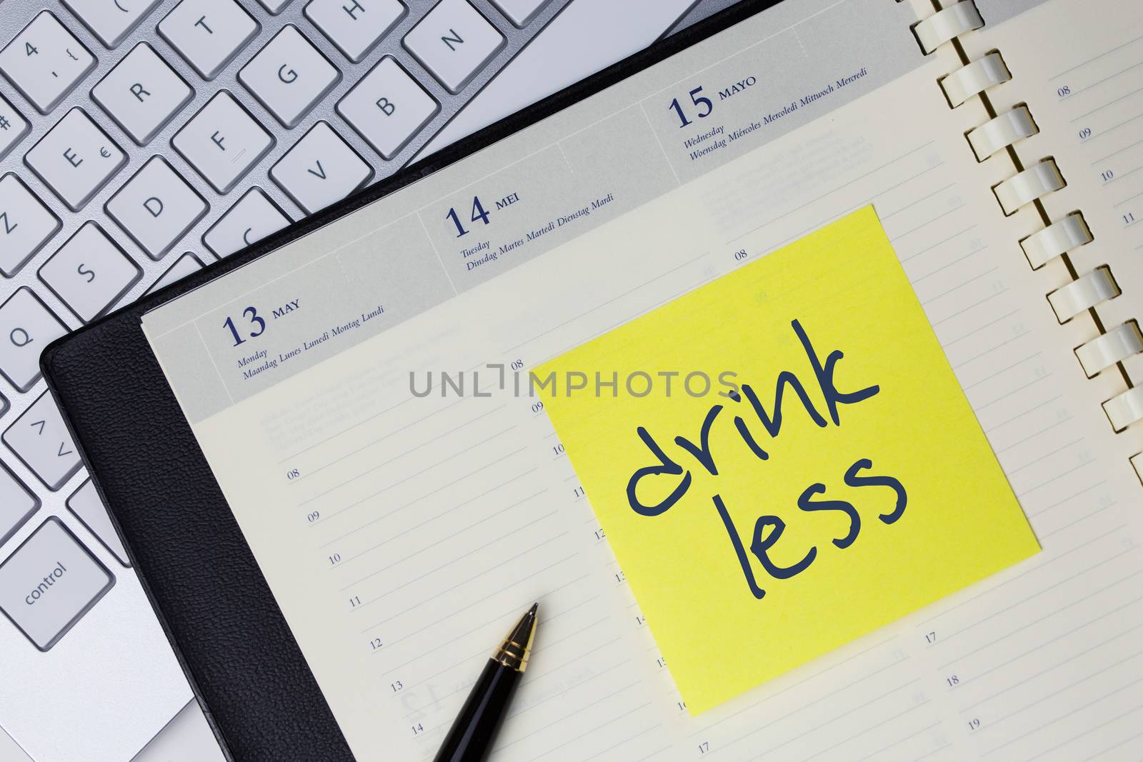 Paper note with the words - Drink less - in business desk. How to get better concept
