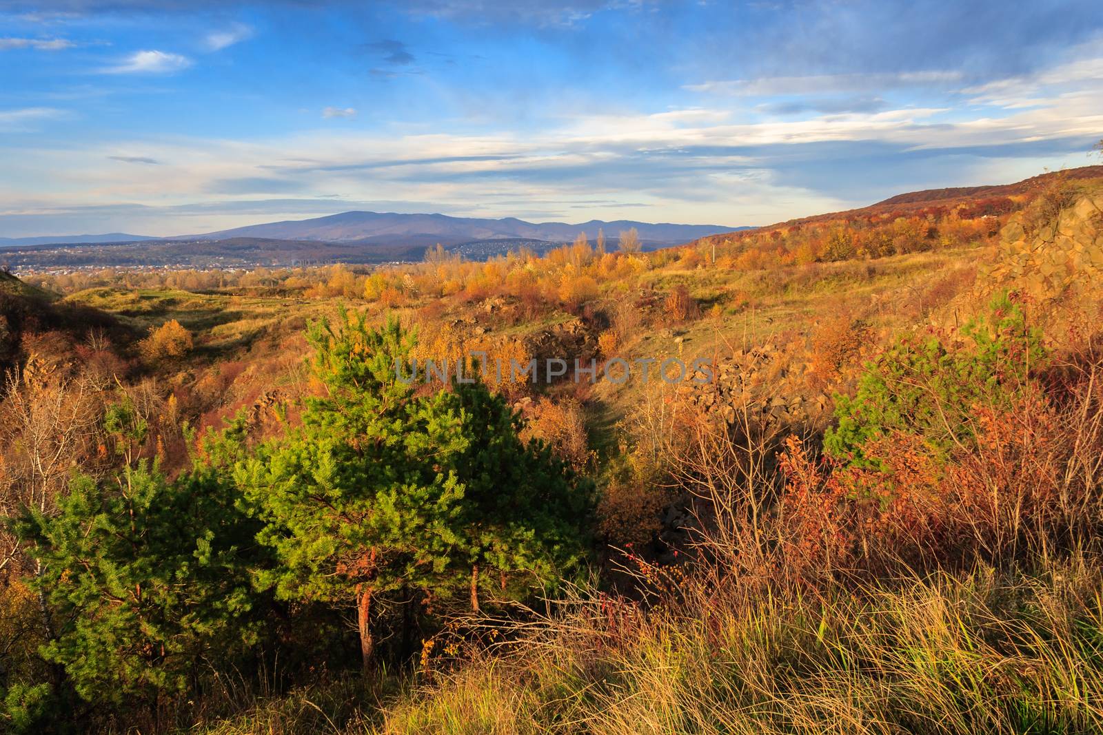 autumn landscape. the view from the high hill to the valley and the mountains far away. vertical