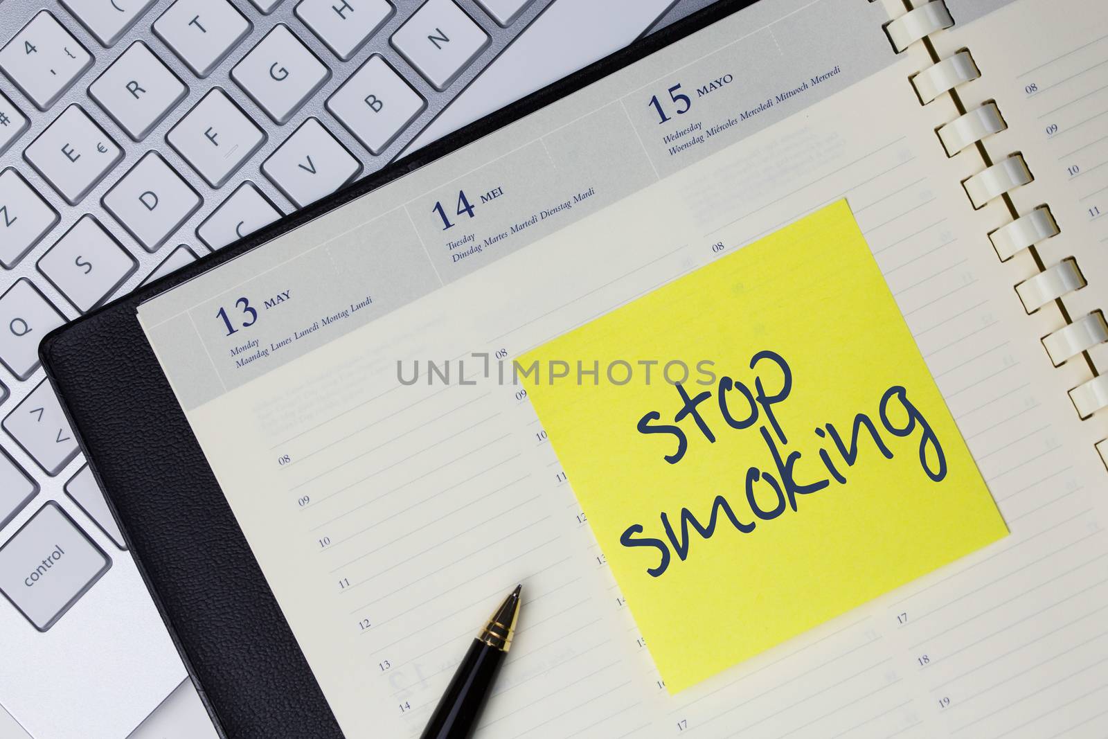 Paper note with the words - Stop smoking - in business desk. Health concept by pixinoo