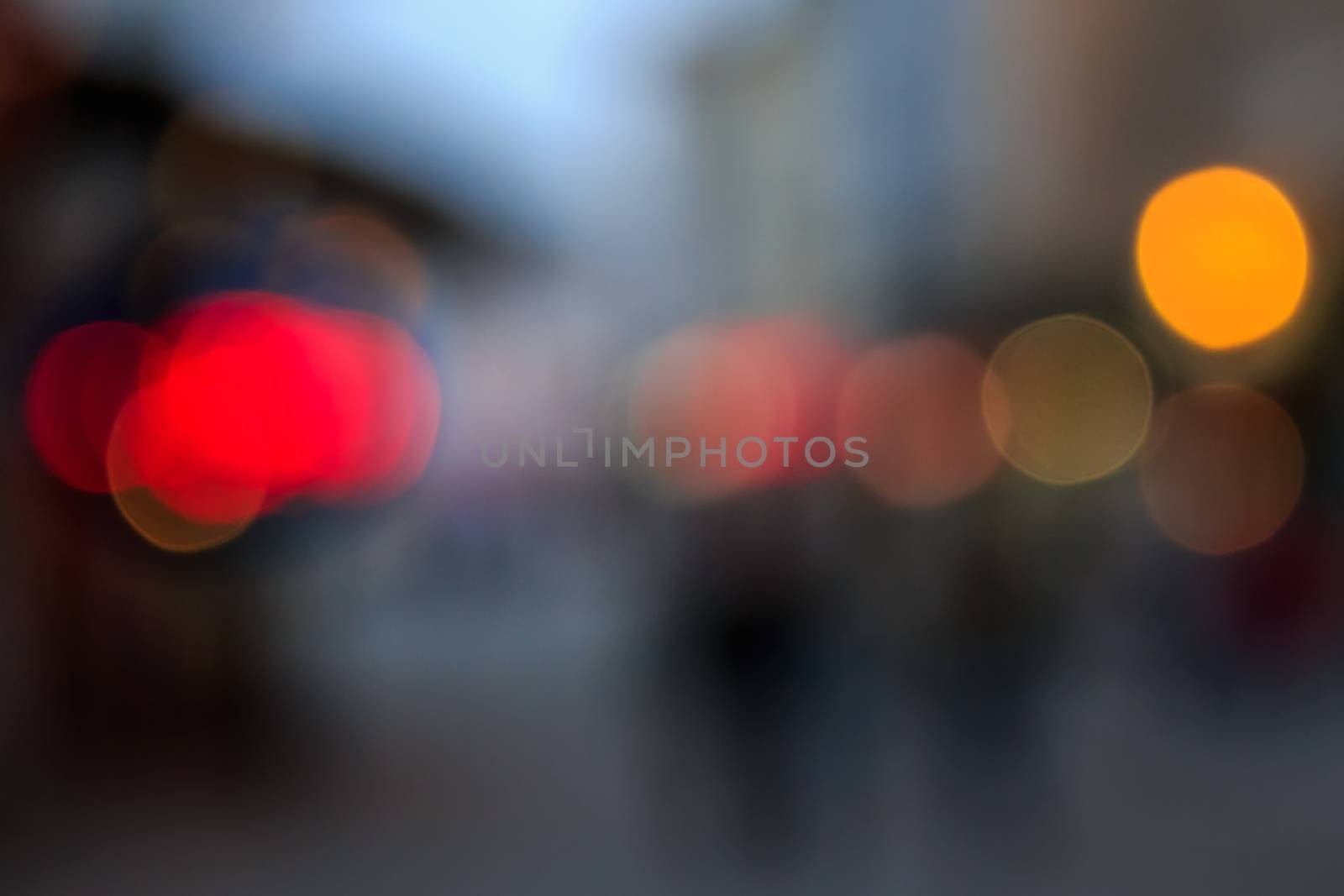 defocused image light of city streetlights in autumn evening