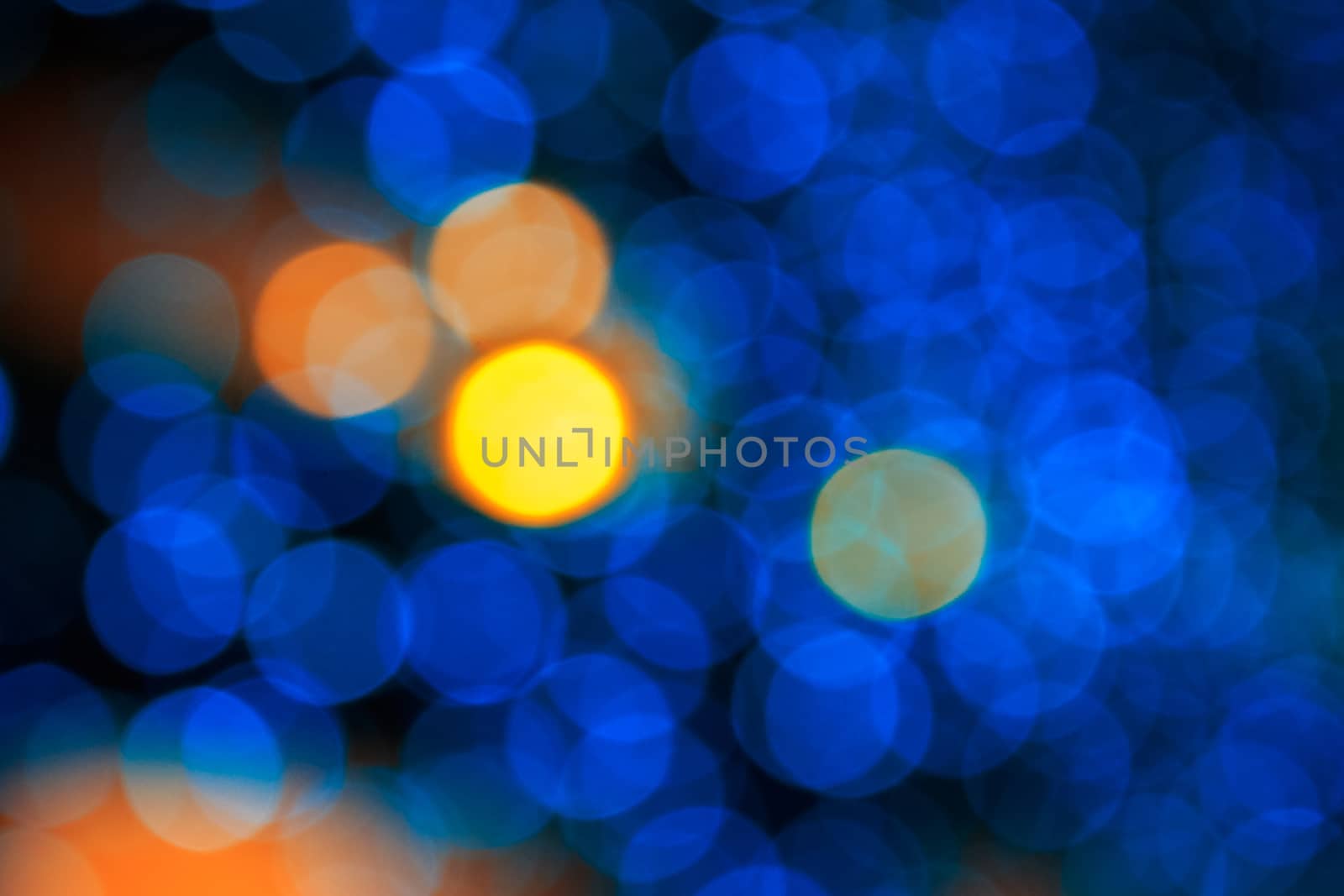 bokeh of yellow circle light on cool blue abstract blur background