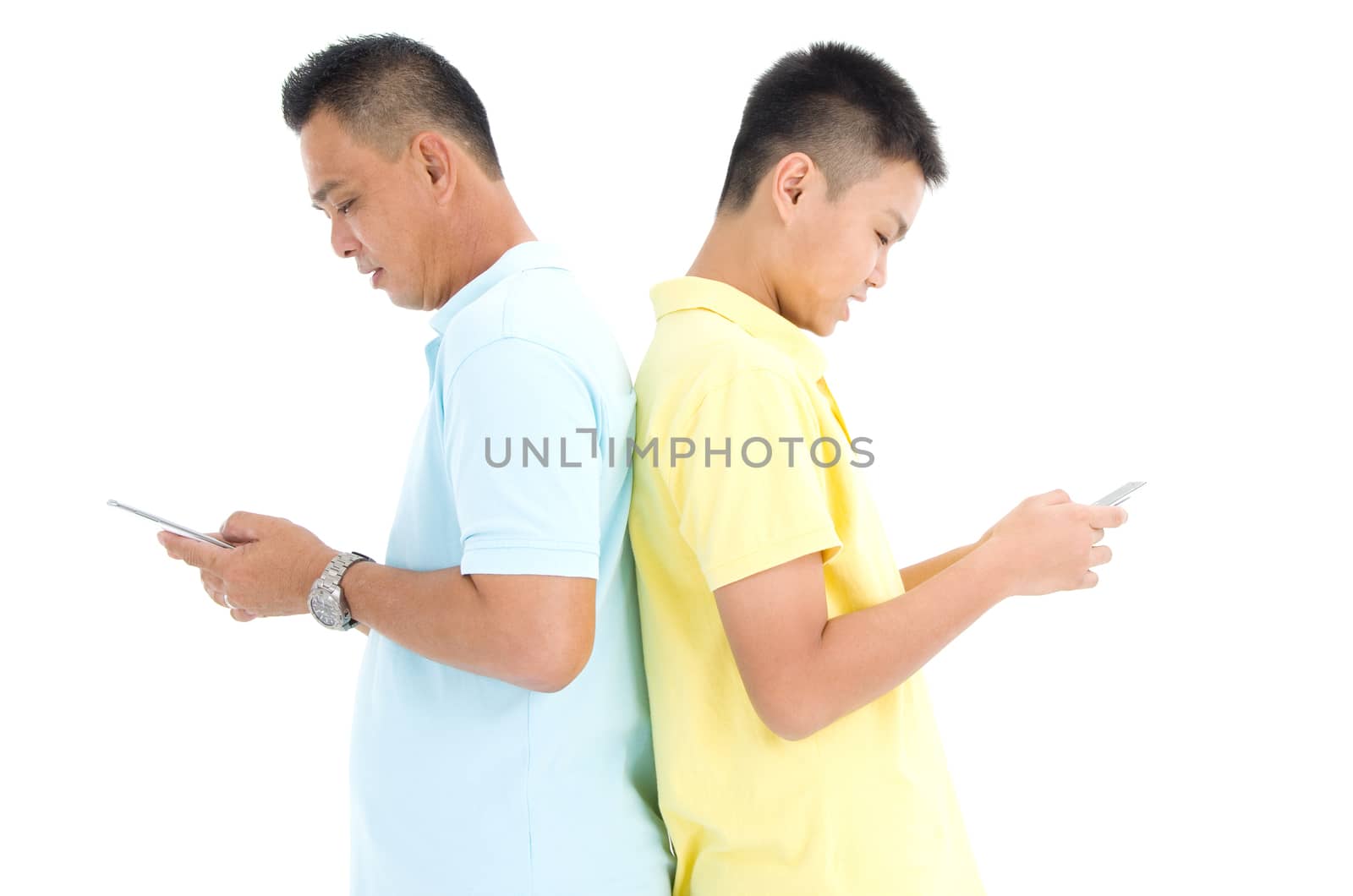 Mother and her son busy with smartphones at home