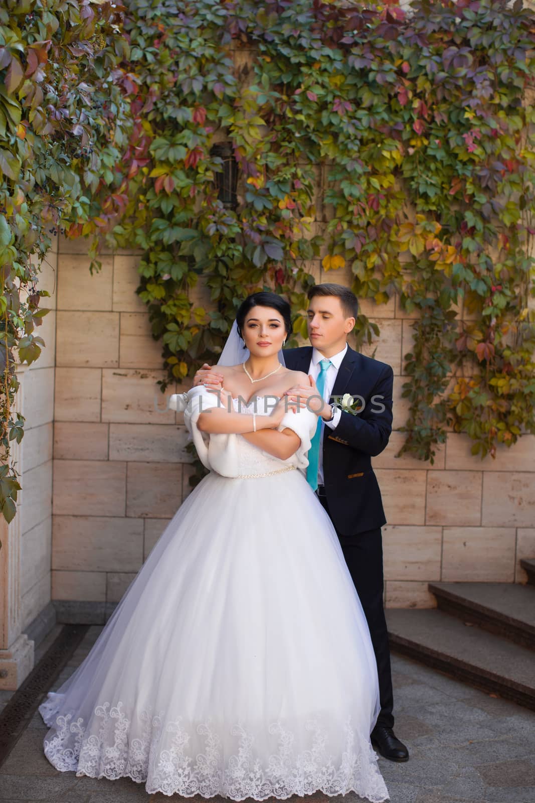 The groom put his hands on the bride's shoulders