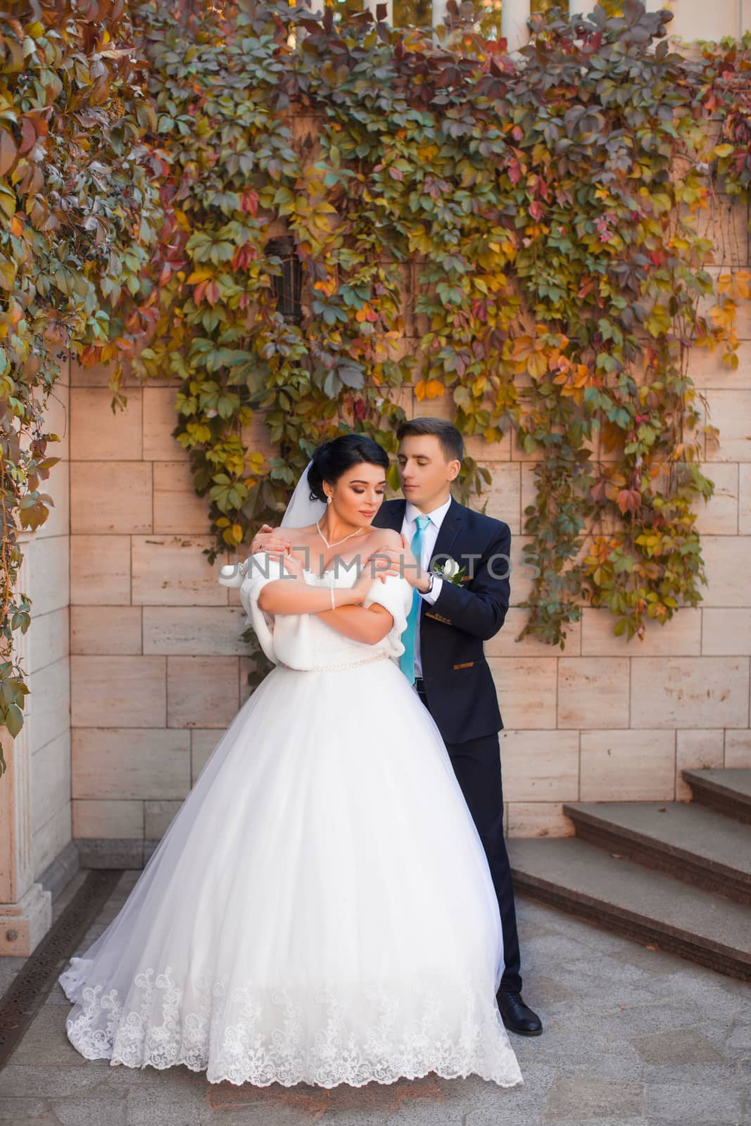 The groom put his hands on the bride's shoulders