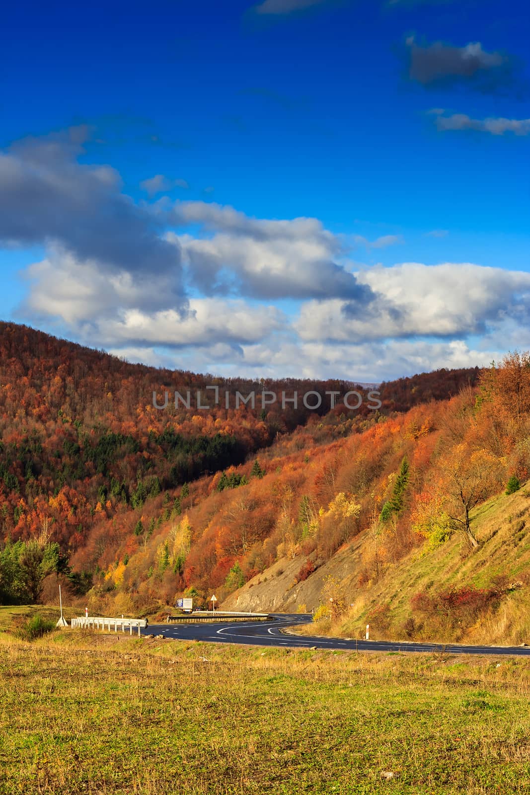 s-curve road in morning at the mountain footwith red and yellow  by Pellinni