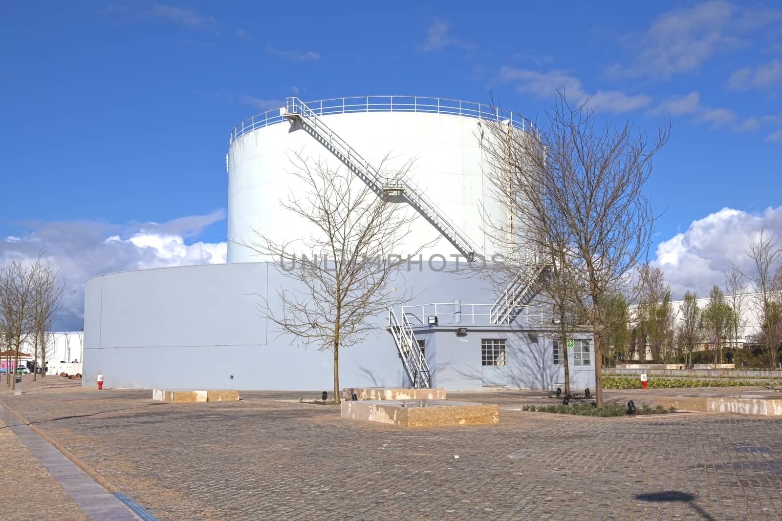 White tanks in tank farm with iron staircase 