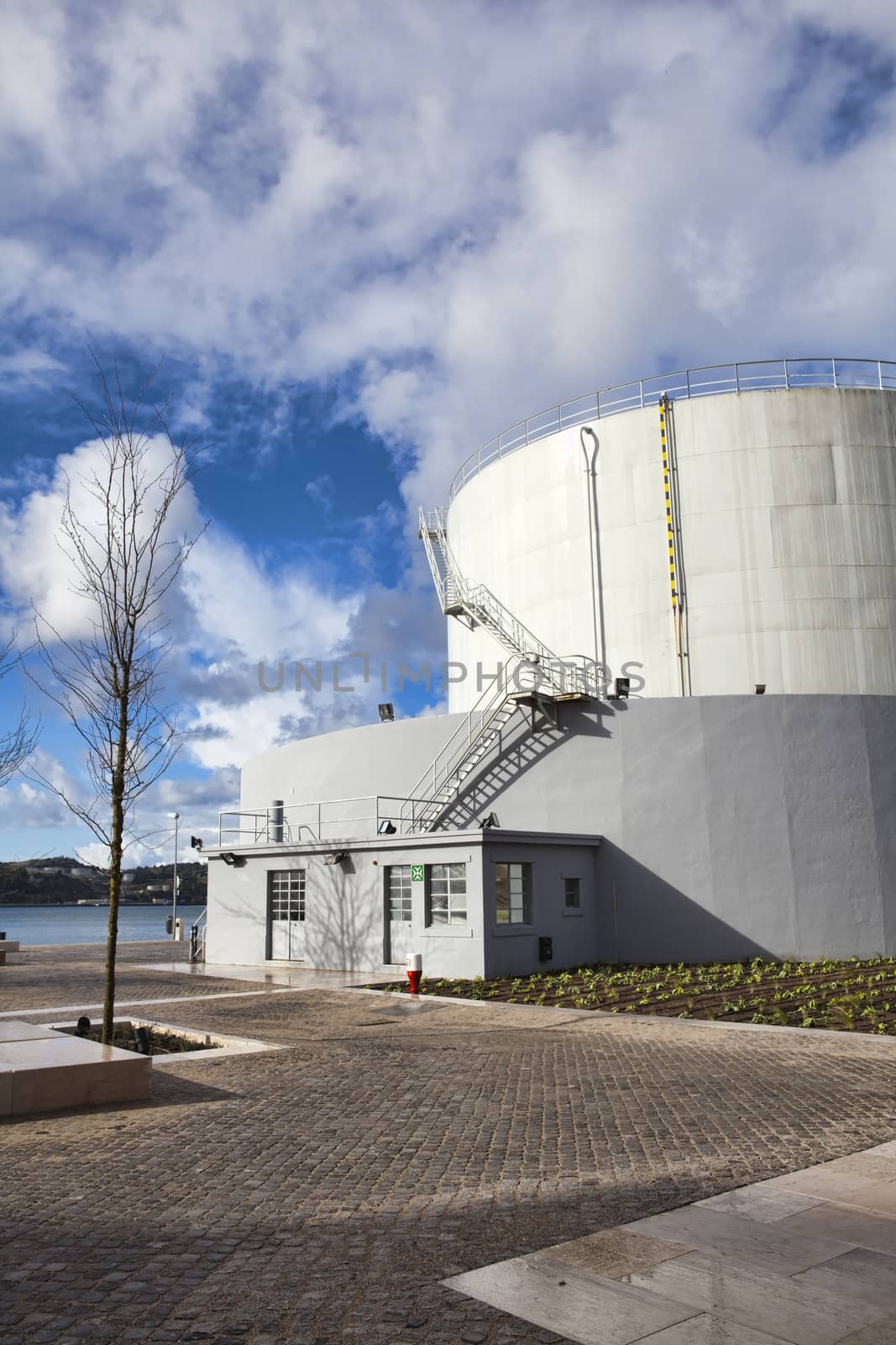 White tanks in tank farm with iron staircase 