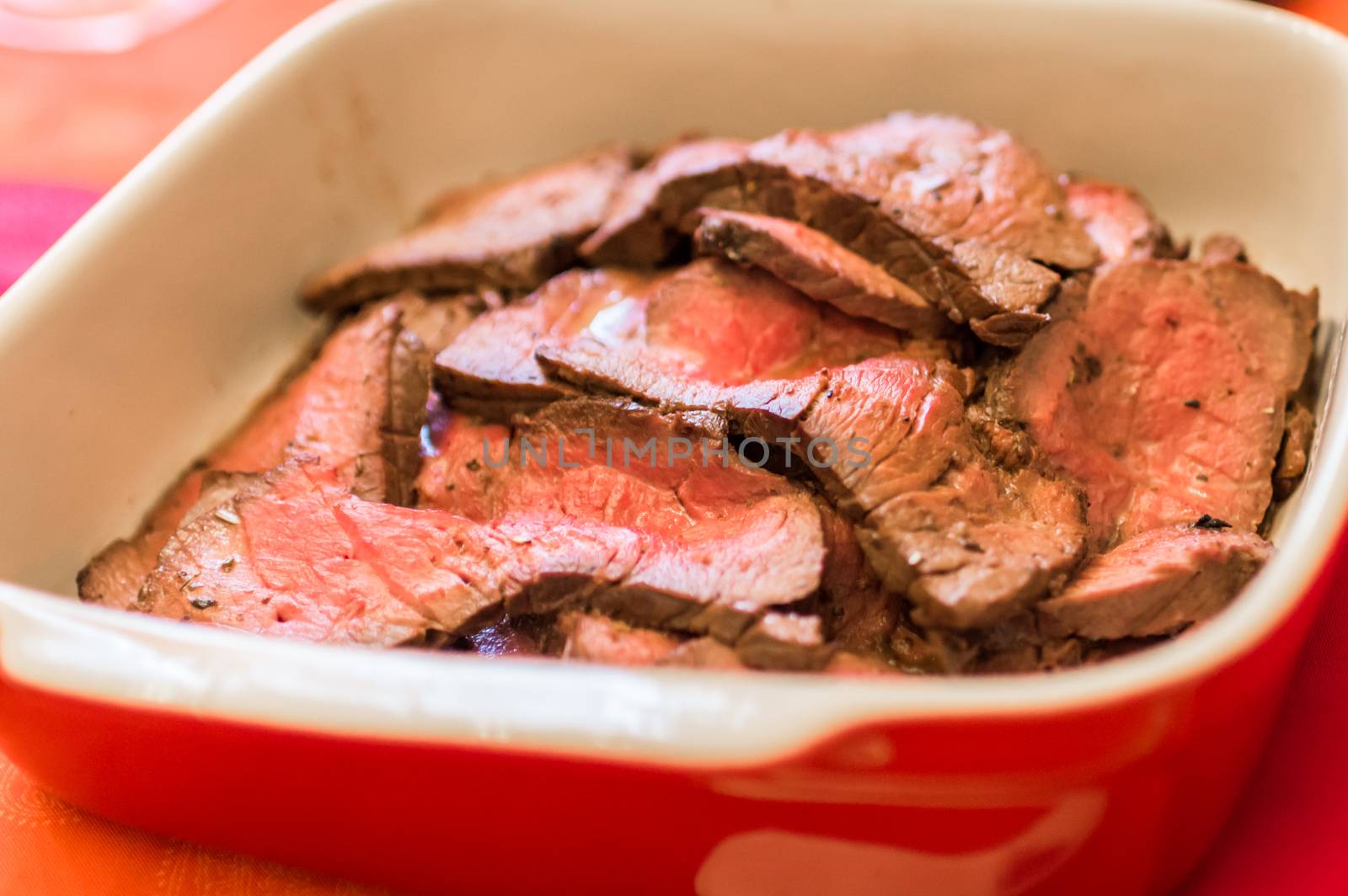 Close up raw chunks of meat in the red pan