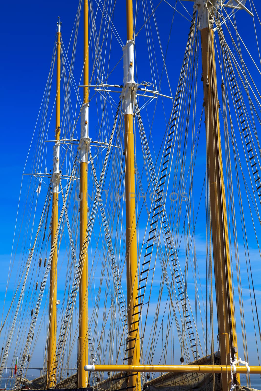 Yacht mast against blue summer sky