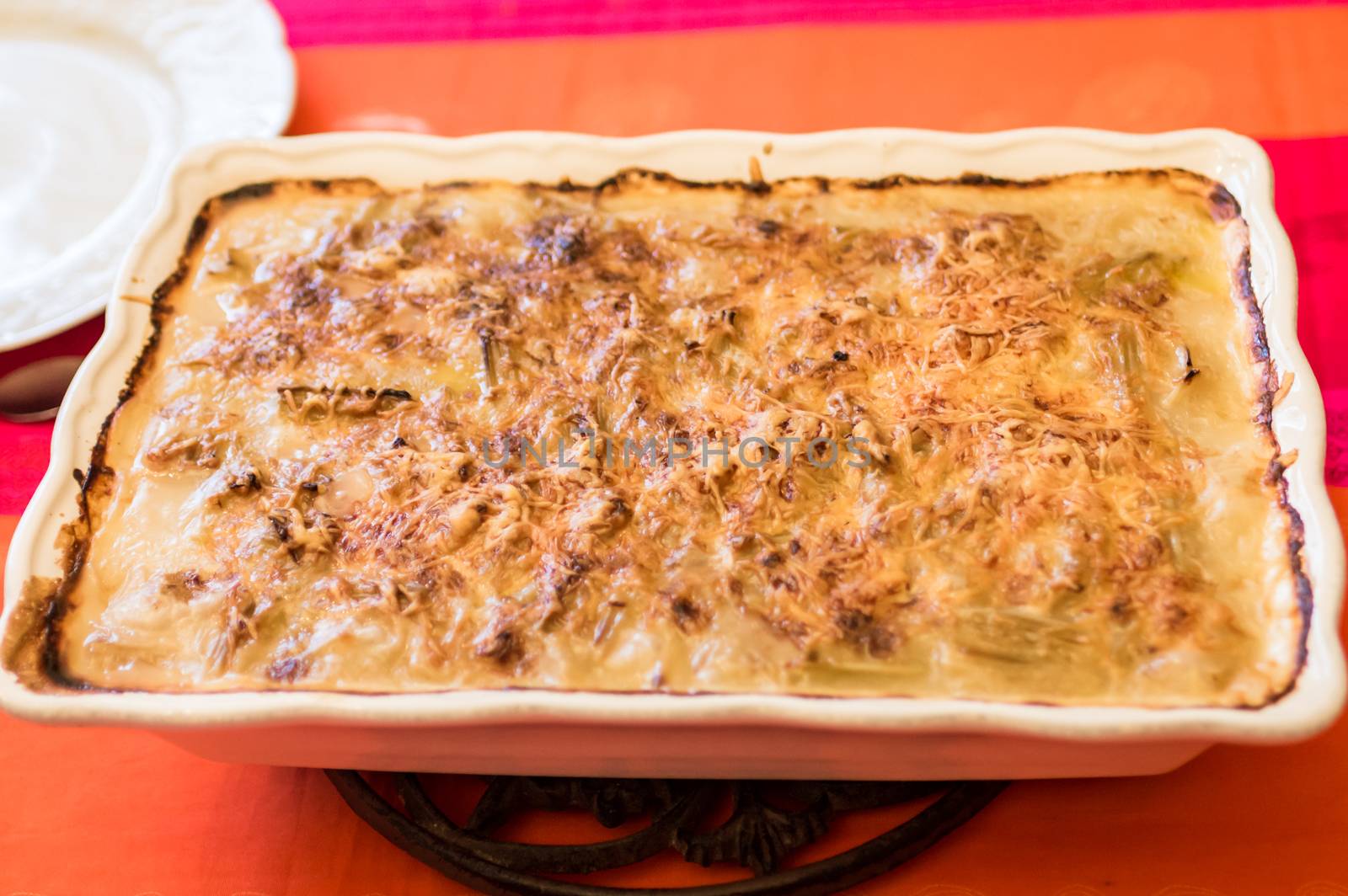 potato casserole with cheese in a glass bowl