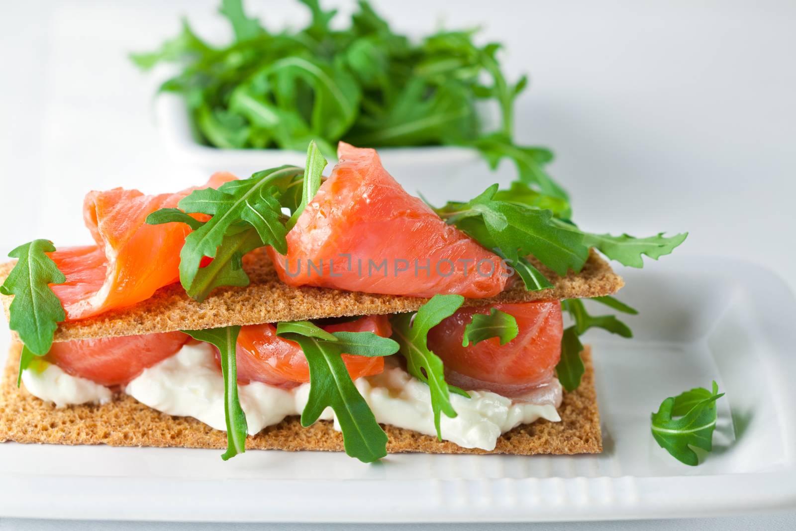 Smoked Salmon on a Healthy Crispbread with Cream Cheese, Fresh Arugula 
