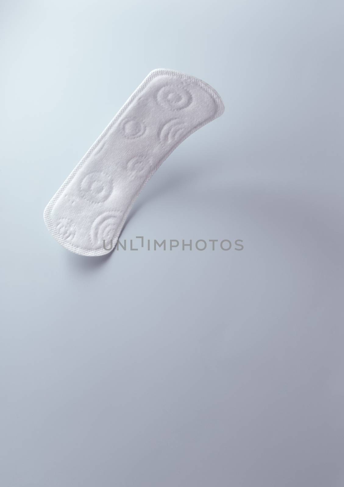 close up view of woman's sanitary pad on color back